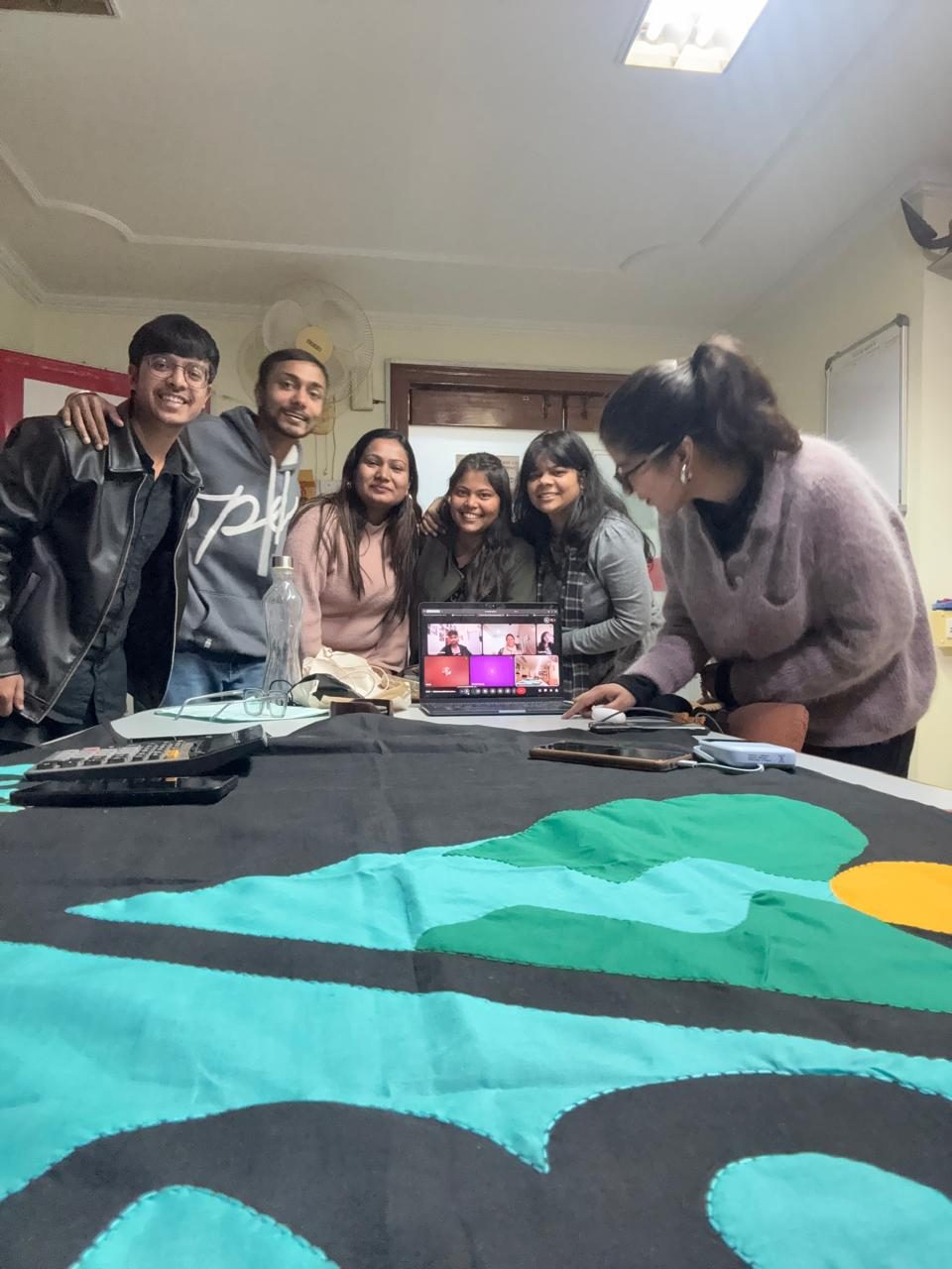 Team members stitching the appliqué banner
