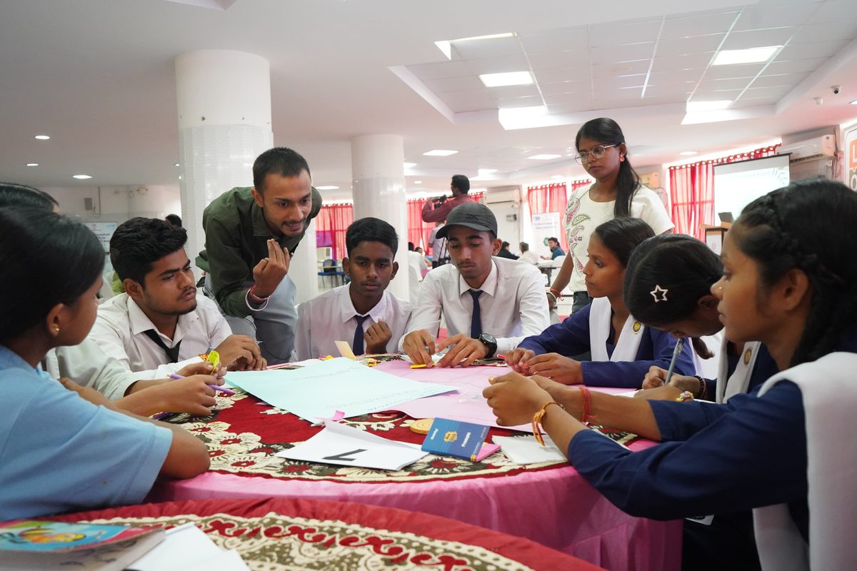 Young people in discussion around a table at a Vithi youth consultation